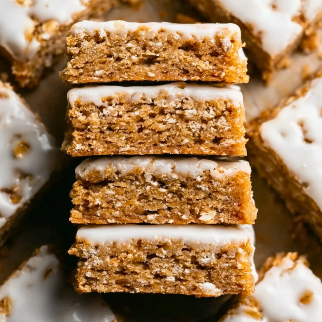 Delicious iced oatmeal cookie bars with creamy icing on a plate