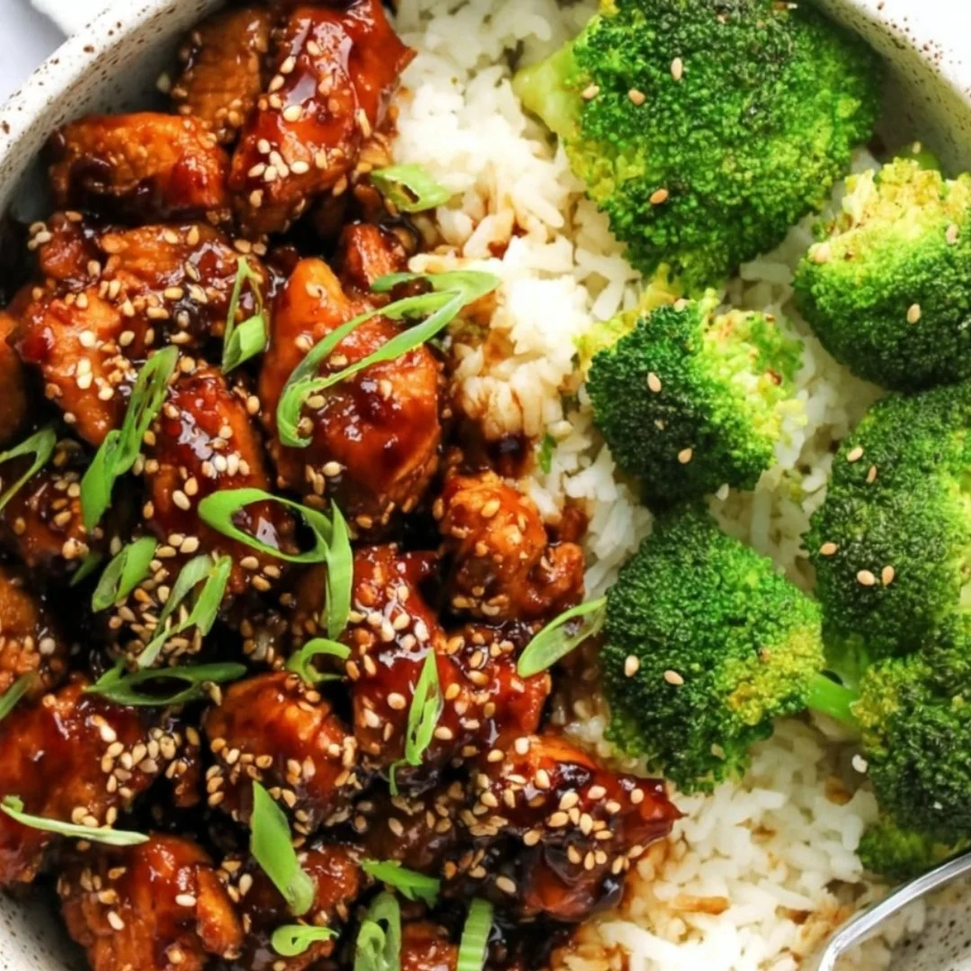 Juicy Air Fryer Teriyaki Chicken garnished with sesame seeds and green onions
