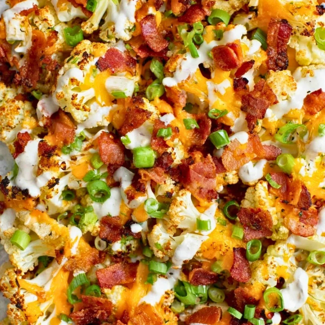 Loaded Roasted Cauliflower topped with cheese and herbs