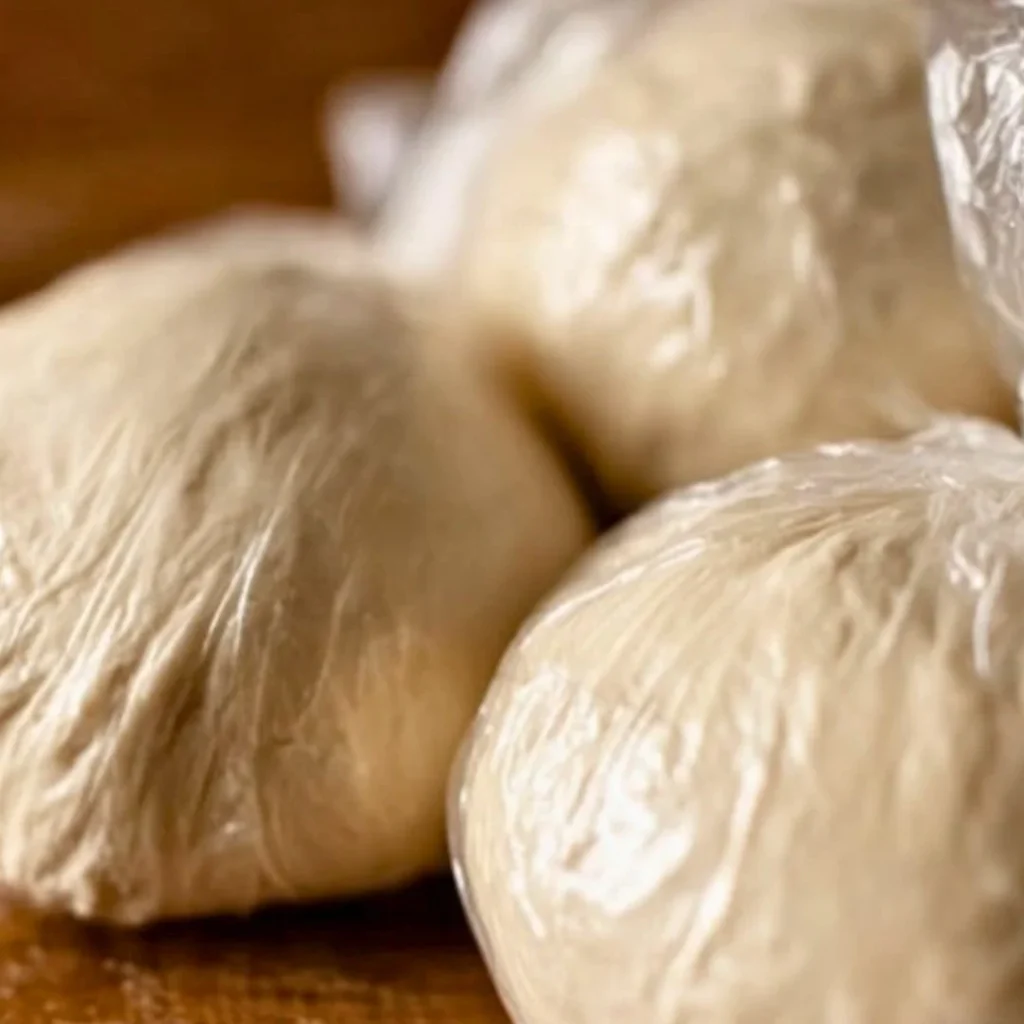 Blue_Salt_Trick_for_Men_Recipe_05 A bright, fizzy blue beverage with granulated salt crystals and a clear jar on a granite surface.
