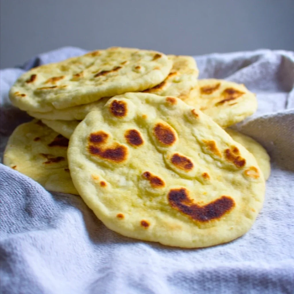 Blue_Salt_Trick_for_Men_Recipe_05 A bright, fizzy blue beverage with granulated salt crystals and a clear jar on a granite surface.