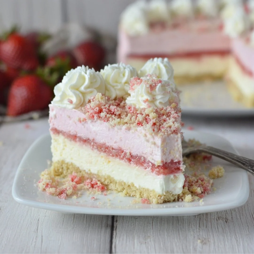 Slice of Strawberry Crunch Cheesecake with fresh strawberries and a crunchy topping