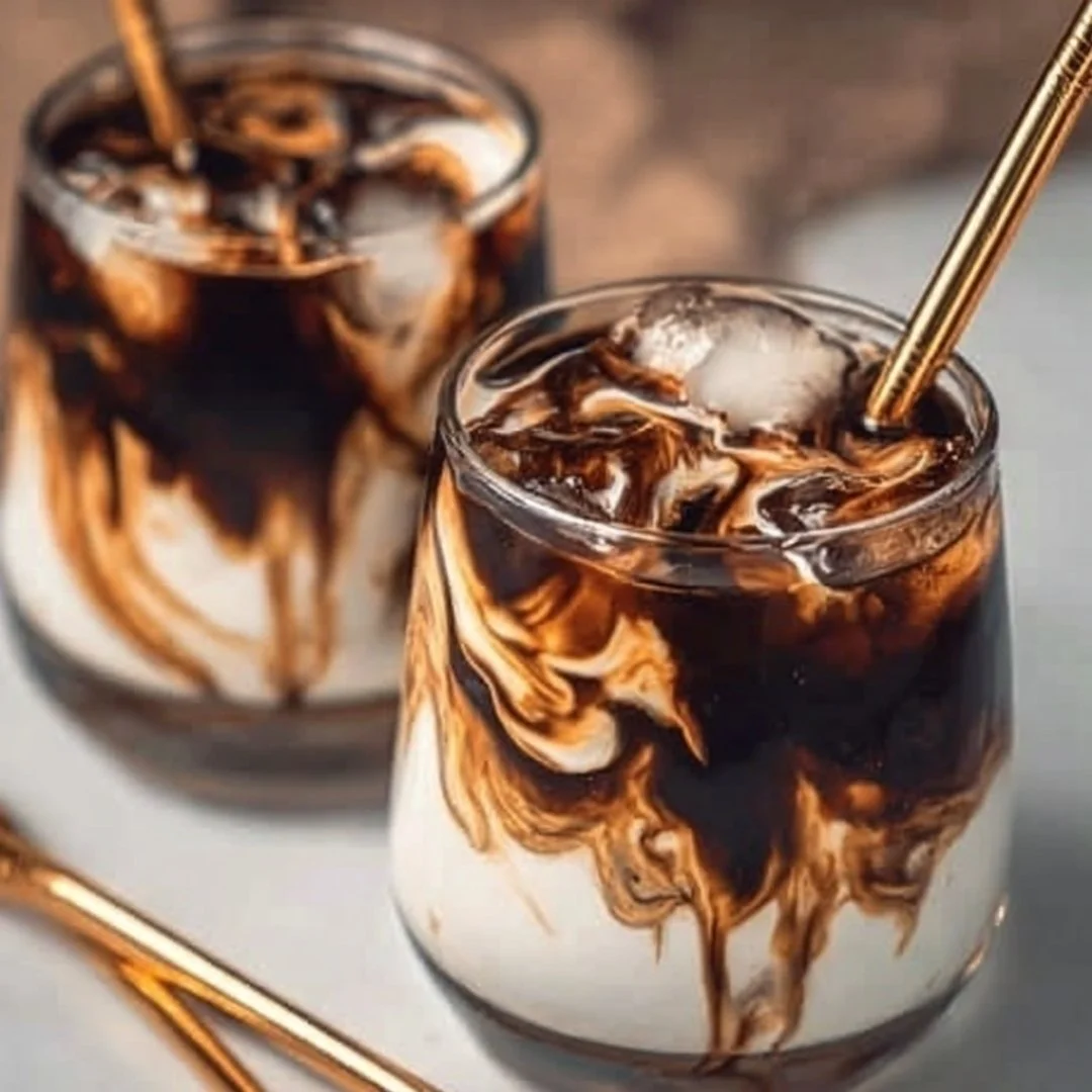 Campfire Cola Dirty Soda served in a glass with marshmallows and chocolate